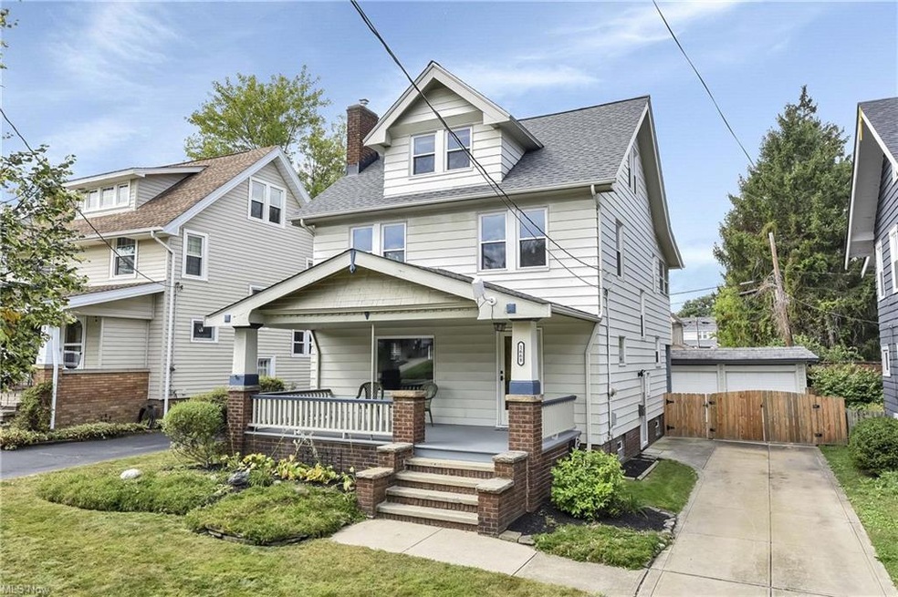 Welcome to 1668 Lewis featuring a large Lakewood style porch, newer concrete drive and lovely wooden gate
