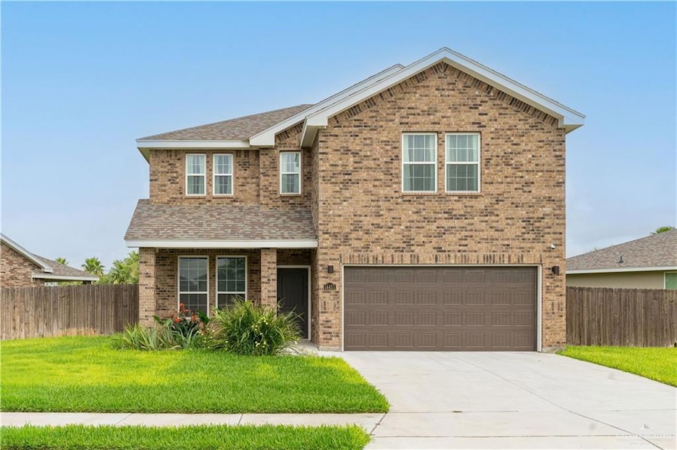 Traditional home featuring brick siding, a garage, driveway, and roof with shingles