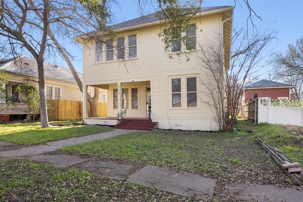 View of front of property with a front lawn, a po