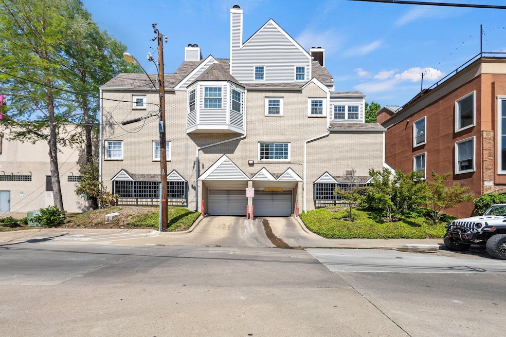 View of property featuring concrete driveway, a ch