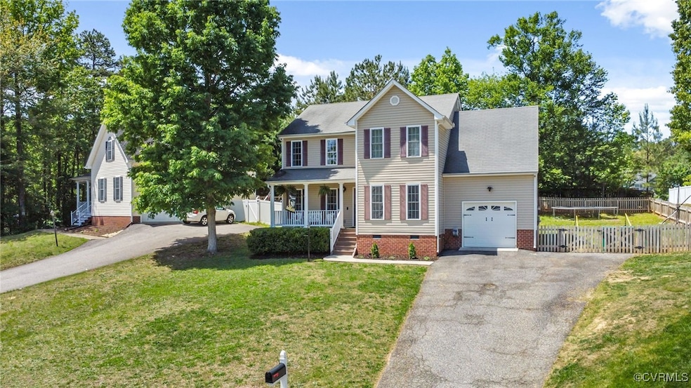 Colonial house featuring covered porch, asphalt dr