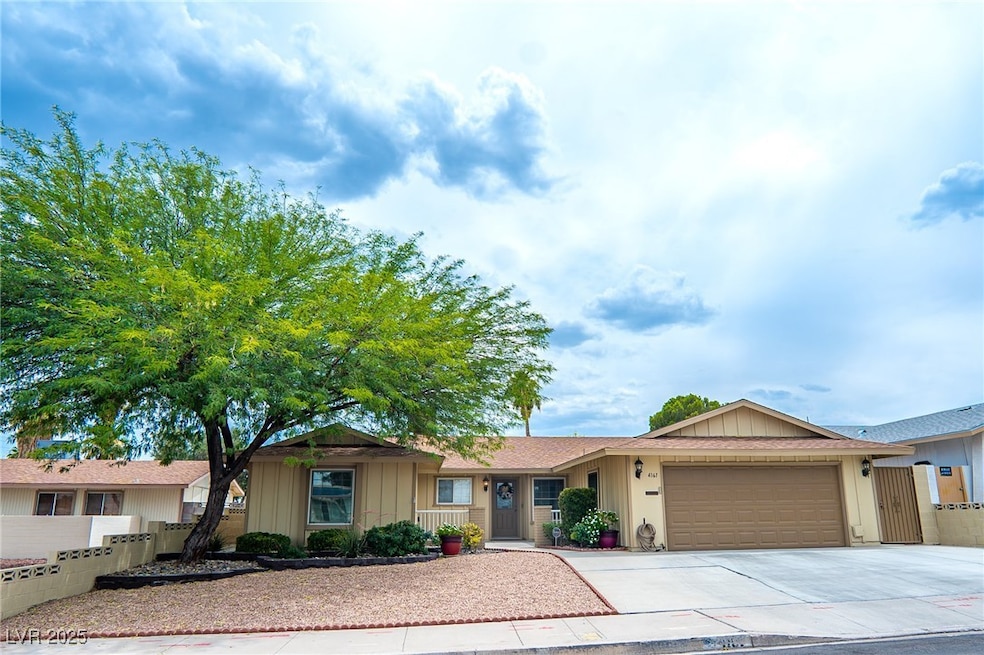 Ranch-style home with a garage, concrete driveway,