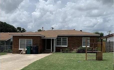Back of house featuring a lawn