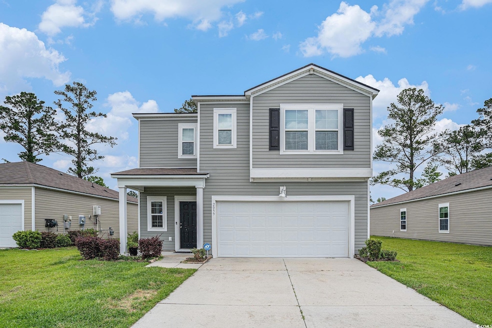 Traditional-style house with a garage, concrete dr