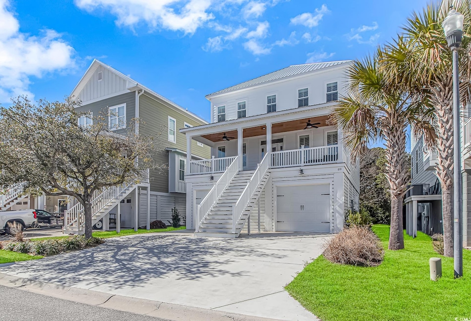 Coastal inspired home featuring a ceiling fan, con