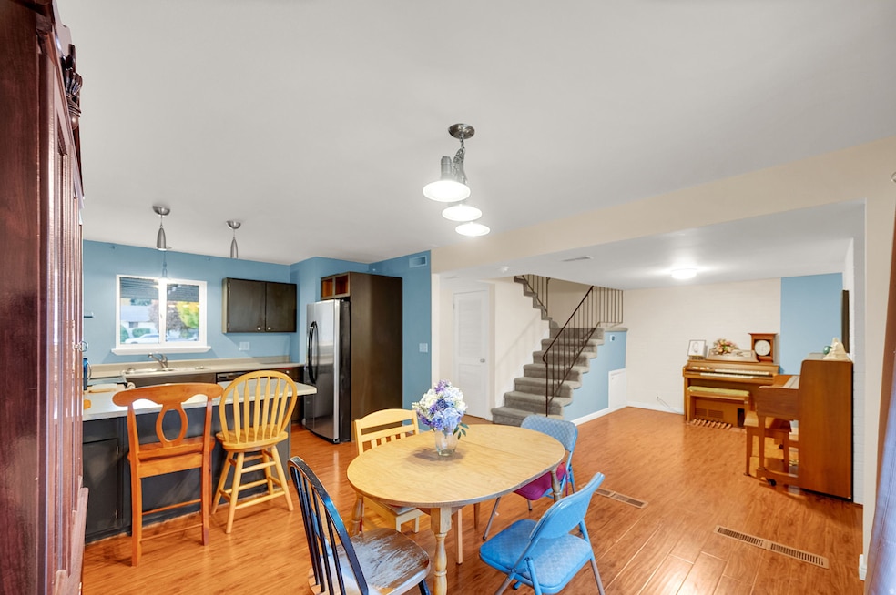 Dining space featuring stairway and light wood-style flooring