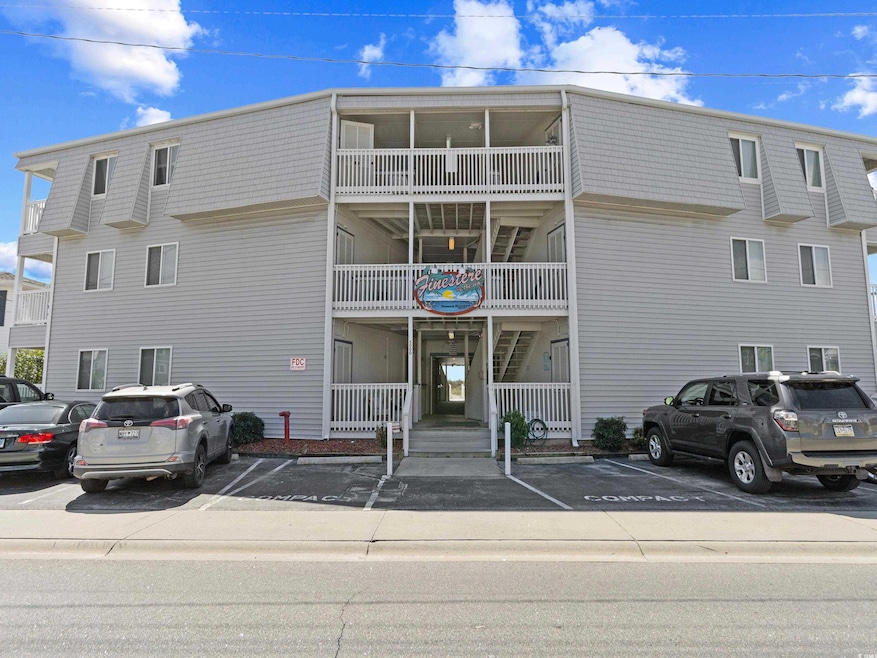 View of property featuring uncovered parking