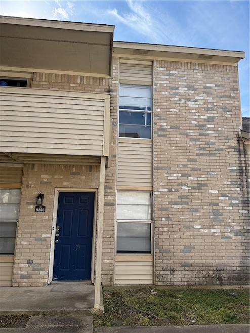 Doorway to property with brick siding