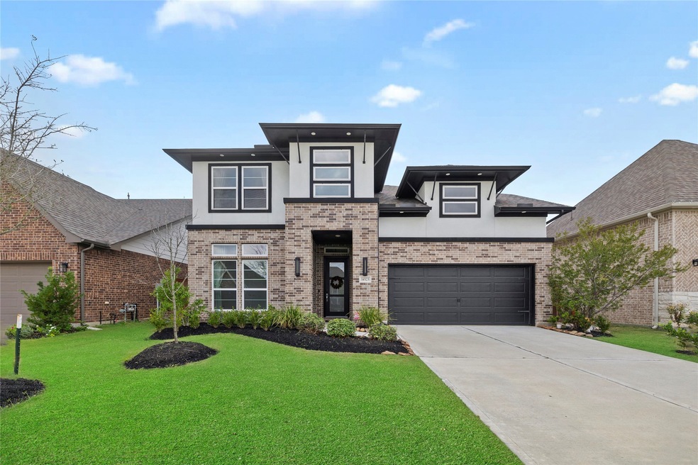 Welcome to your dream home in Cypress built by New Mark in 2021, this stunning two-story residence boasts a beautiful modern elevation of brick and stucco.