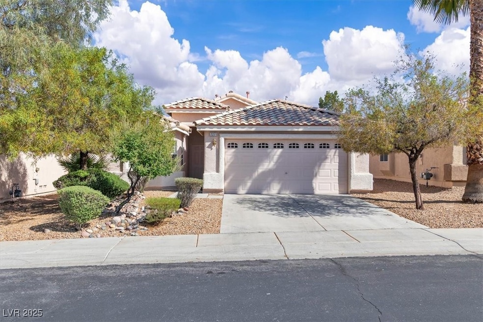 View of front facade with a garage, stucco siding,