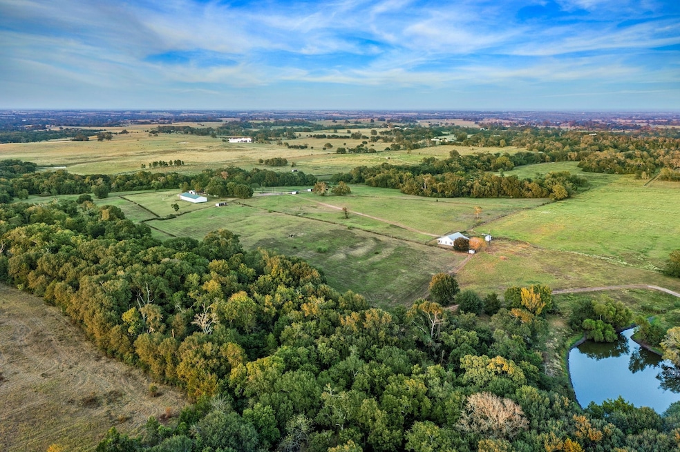 Wooded trails surround 2 sides of property.