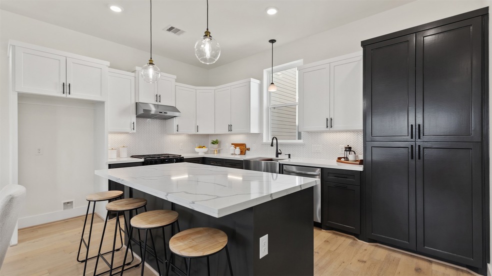 Modern kitchen featuring whitecountertops, a centr