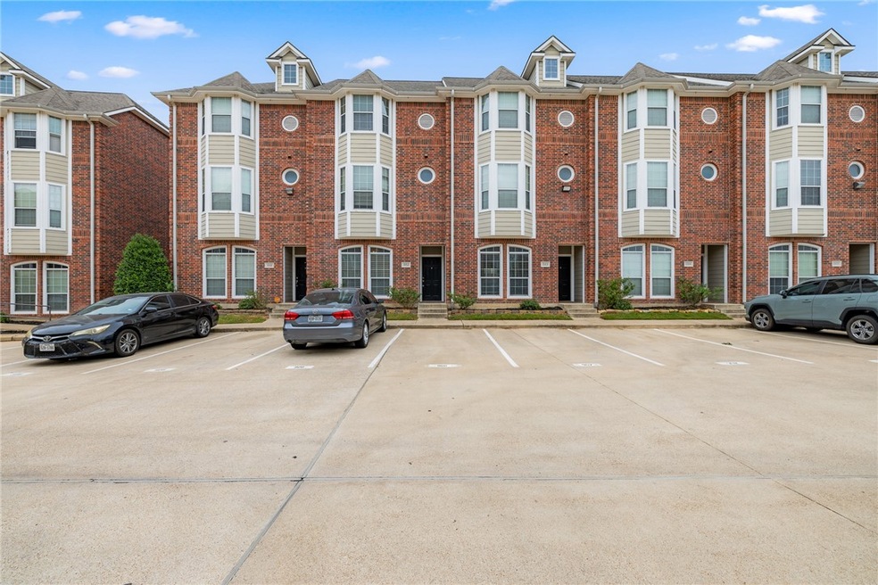 View of property with uncovered parking