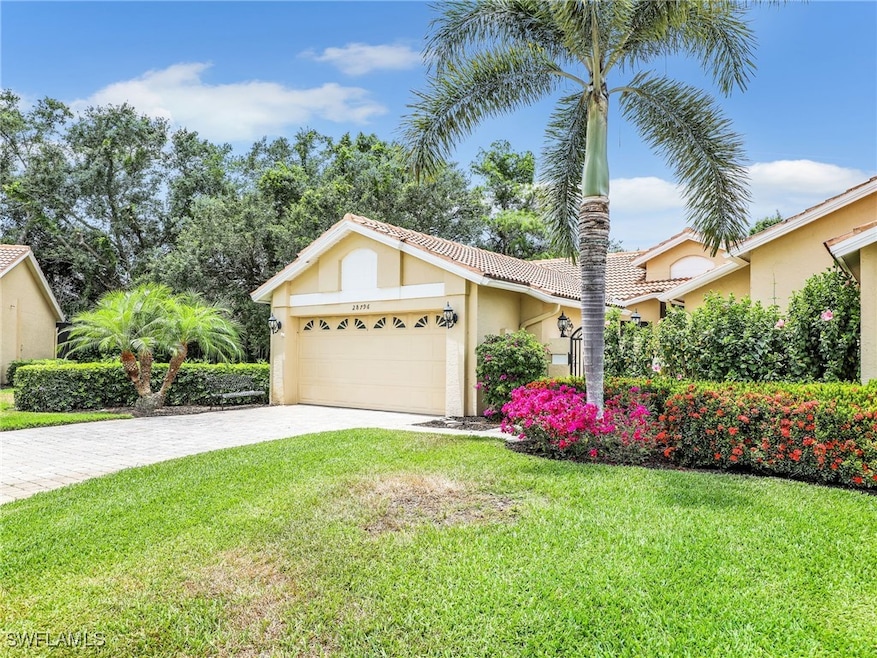 View of front of property with a garage, stucco si