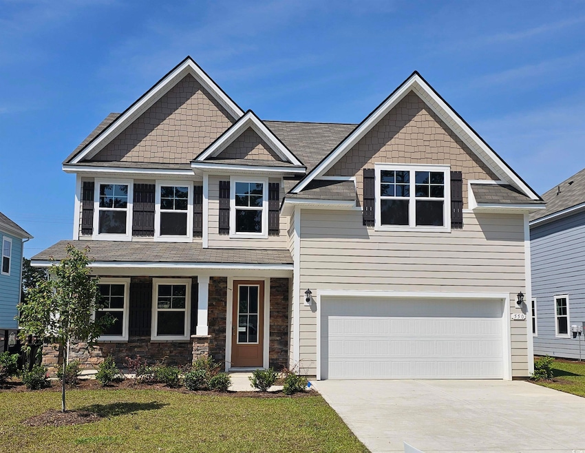 Craftsman-style home with a garage, driveway, and a front yard