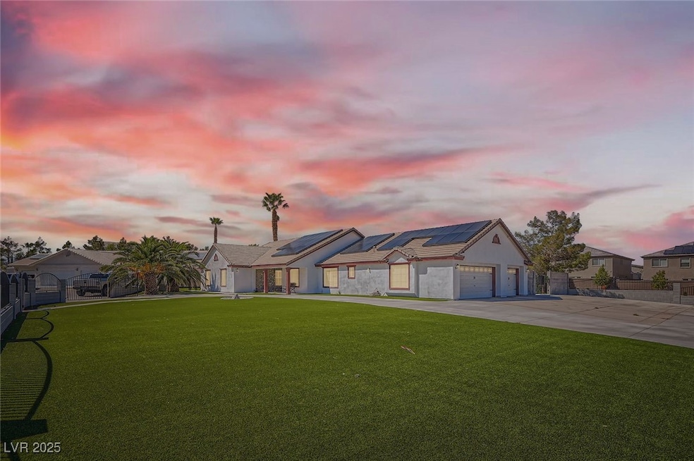 View of front of home with concrete driveway, fenc