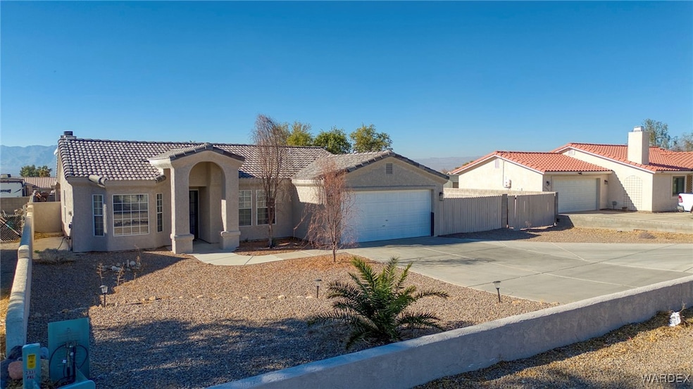 Mediterranean / spanish-style home with a garage