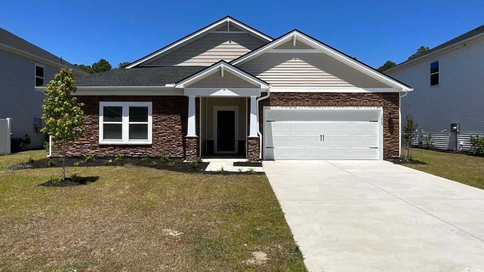 Craftsman house with stone siding, driveway, and a