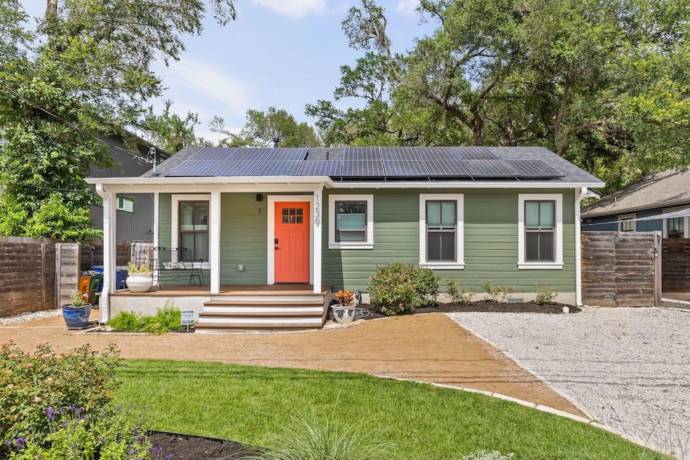 View of front of home featuring a porch and solar