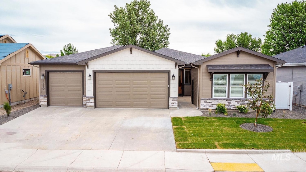 Ranch-style home featuring an attached garage, concrete driveway, a front lawn, and stone siding