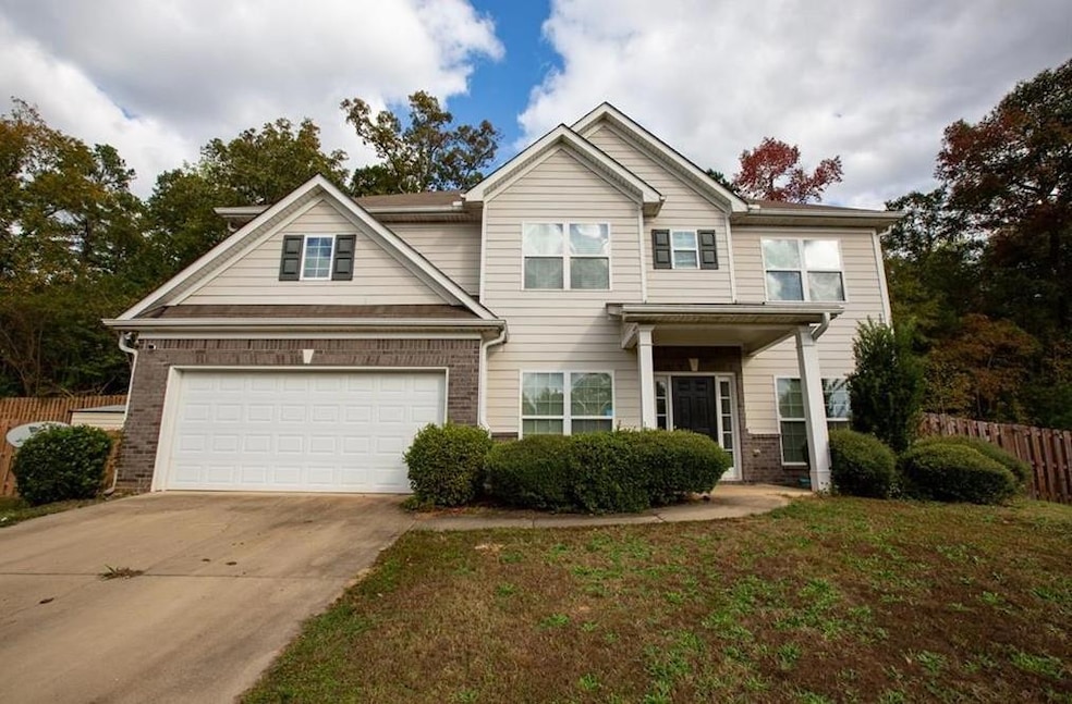View of front of house with a garage, brick siding