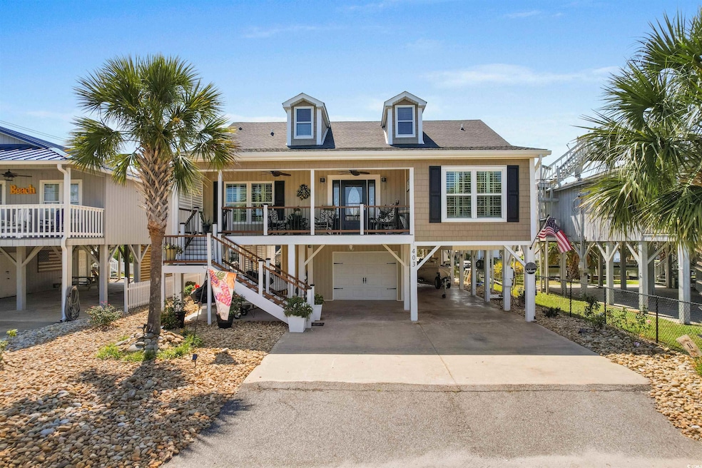 Coastal inspired home with a garage, ceiling fan, 