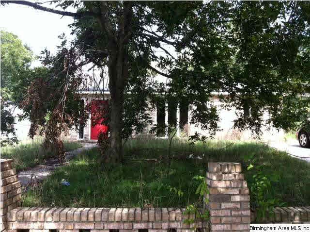 An exterior view of the brick home through the ove