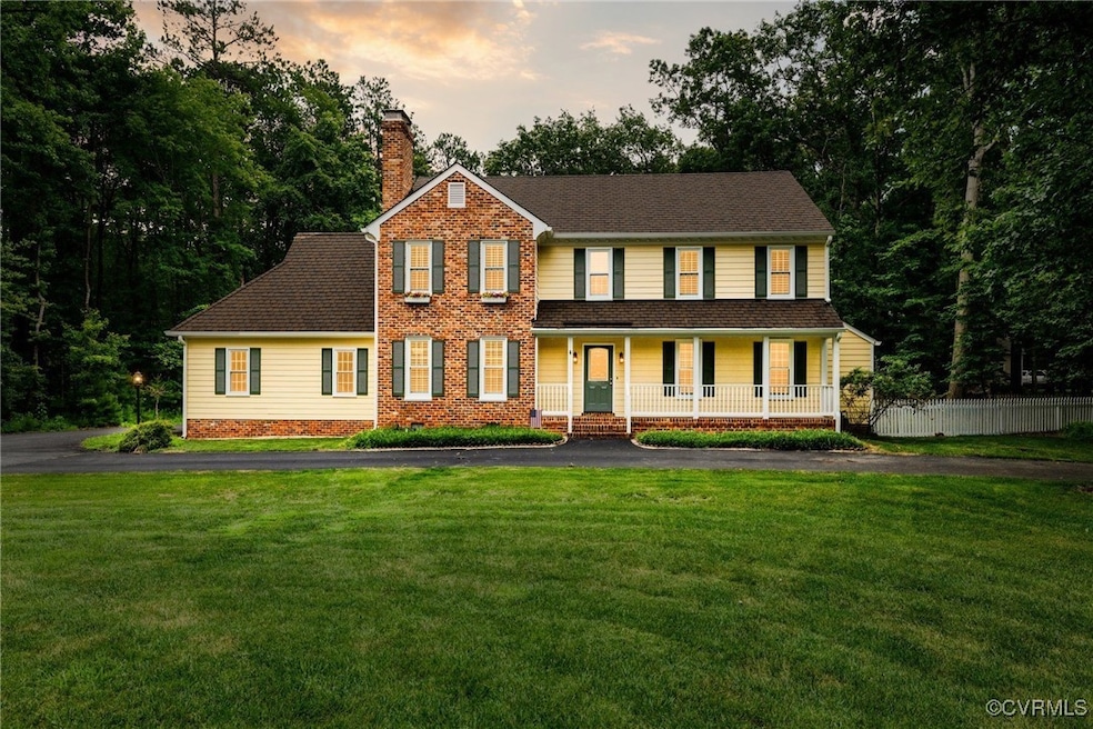 View of front of home with covered porch, a chimne