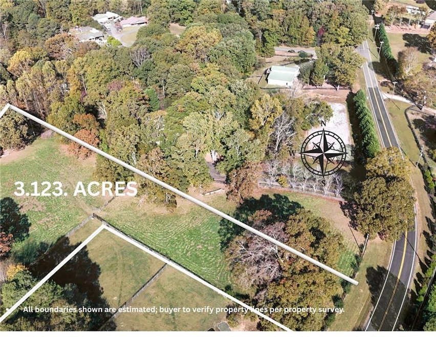 Aerial overview of property's location featuring property parcel outlined and a forest