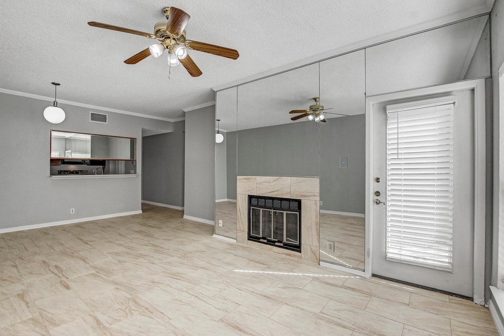 Unfurnished living room featuring a textured ceil