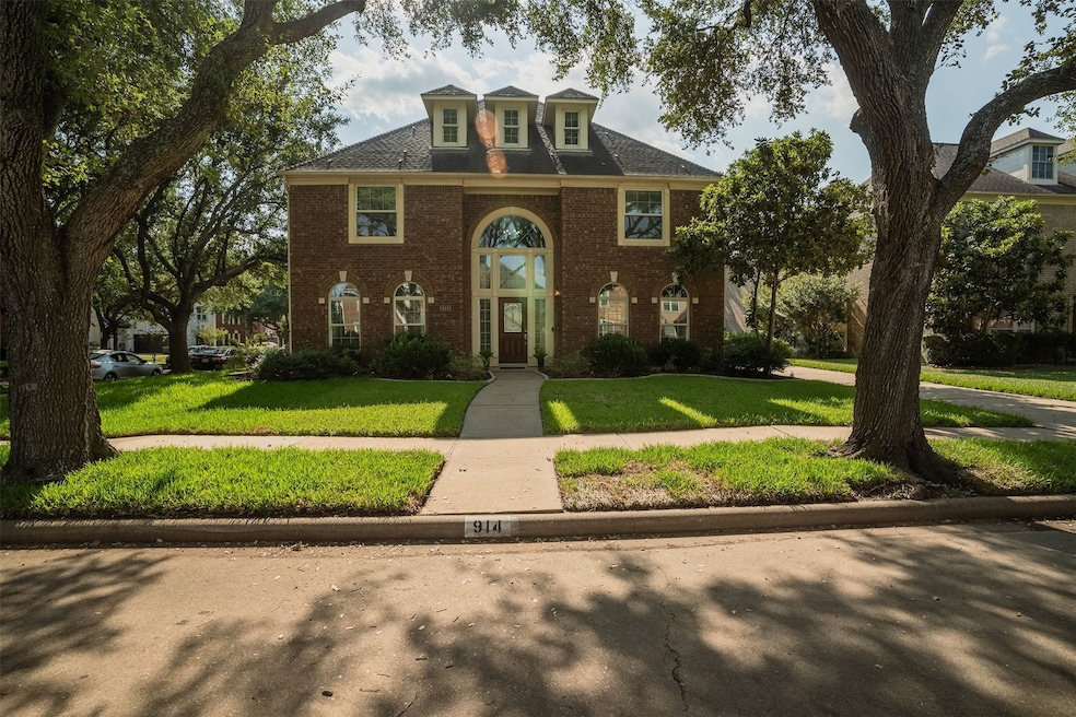 This is a classic two-story brick home featuring a