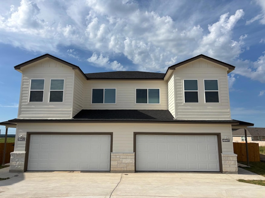 View of front of house with a garage, stone sidin