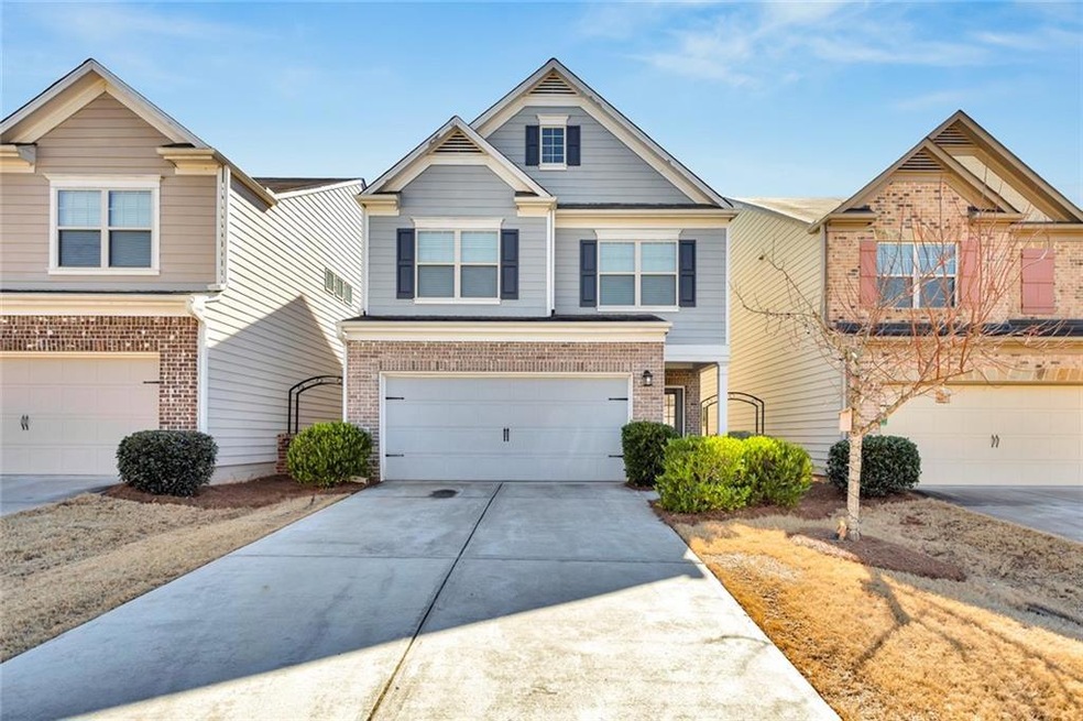 Townhome / multi-family property featuring a garag
