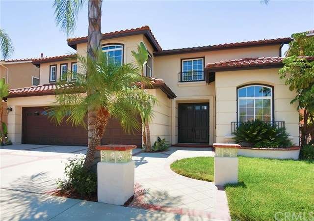 Front of home showing custom landscape and hardsca