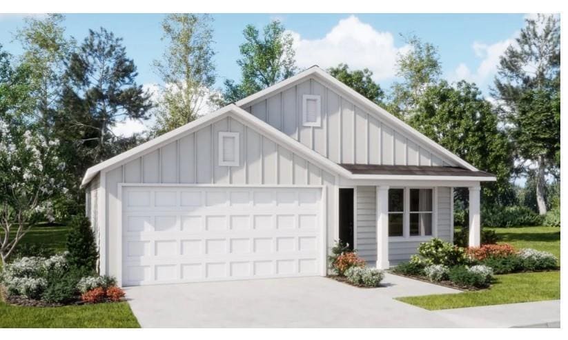 View of front of house with board and batten siding, driveway, and a garage