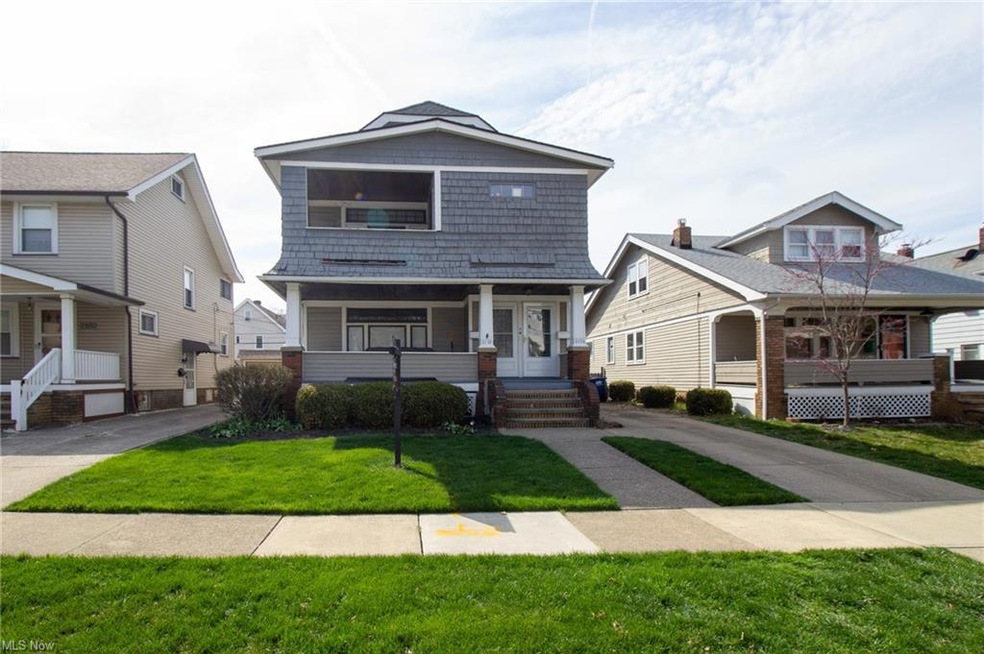 View of front facade featuring a front lawn and a porch