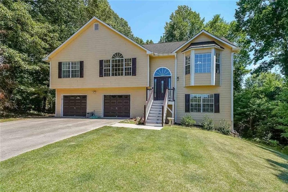 Split foyer home with a front lawn and a garage