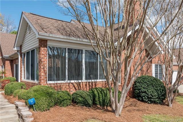 Front of home and exterior of sunroom. Walkway to 