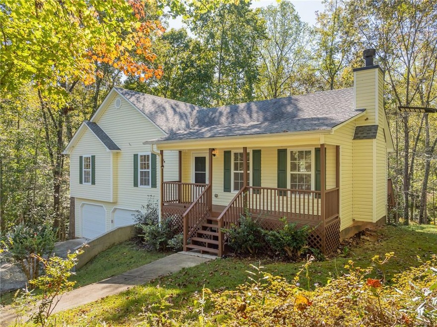 Ranch-style home featuring a porch and a garage