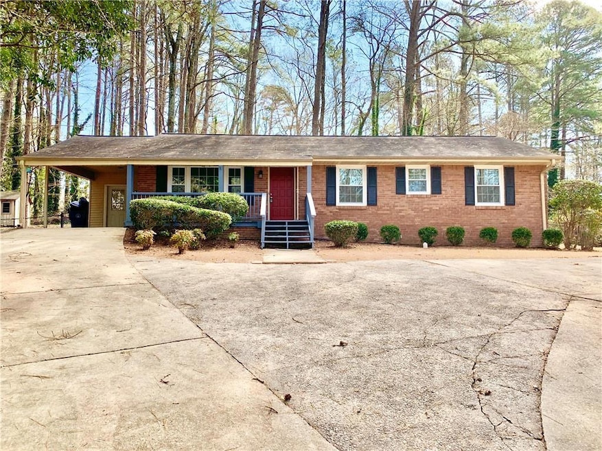 Single story home featuring covered porch, drivewa