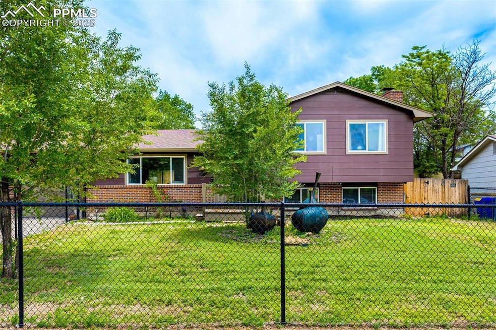 Split level home featuring brick siding and a chimney
