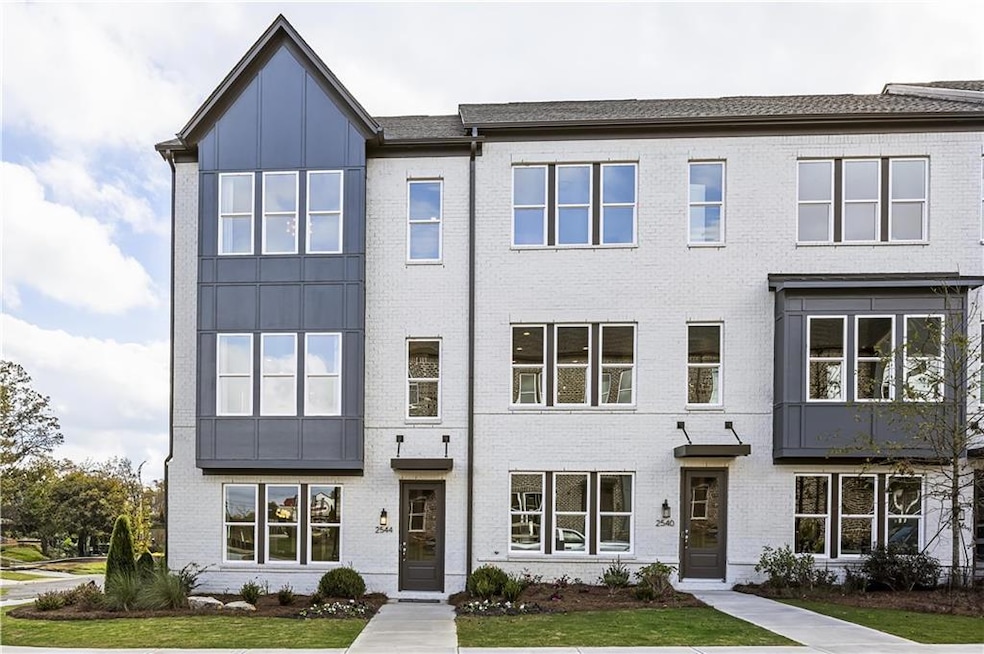 Townhome / multi-family property with a front yard