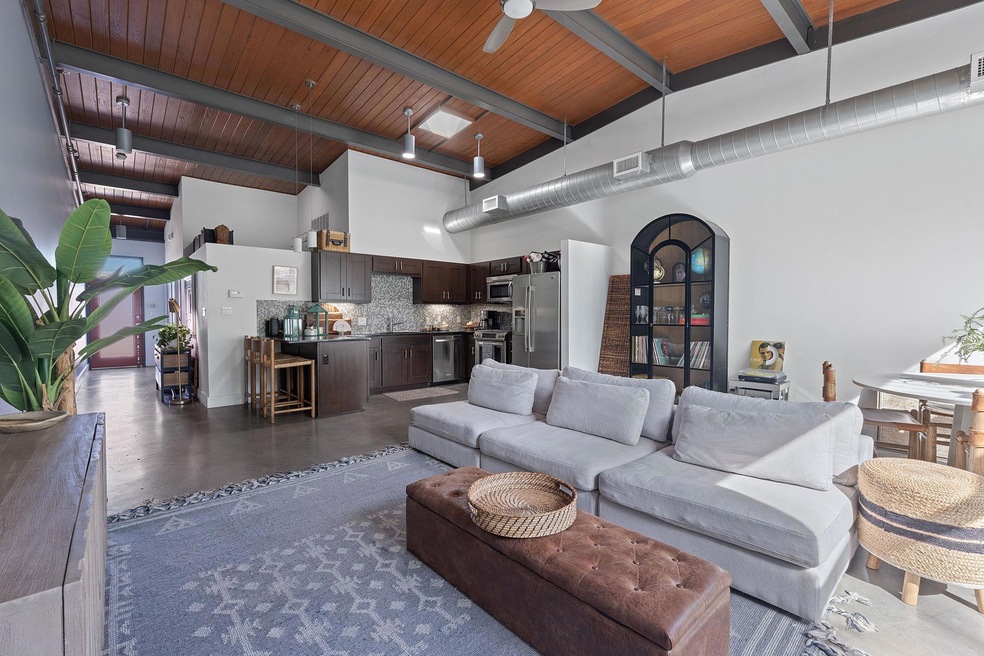 Living area with beam ceiling, wood ceiling, arch