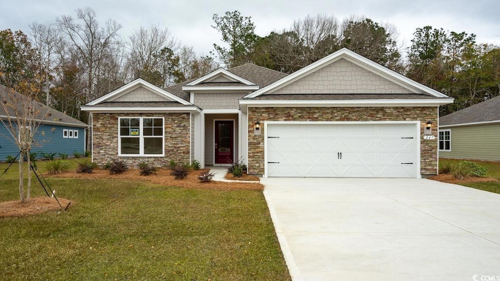 Craftsman inspired home featuring stone siding, a front lawn, concrete driveway, and an attached garage