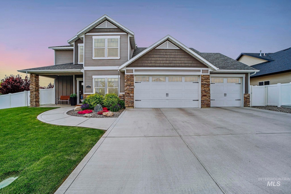 View of front of house featuring stone siding, concrete driveway, a garage, covered porch, and board and batten siding