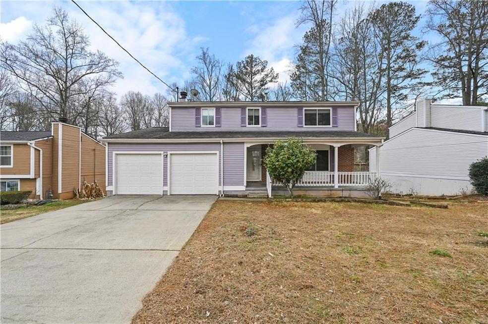 Traditional home with a garage, a front lawn, cove