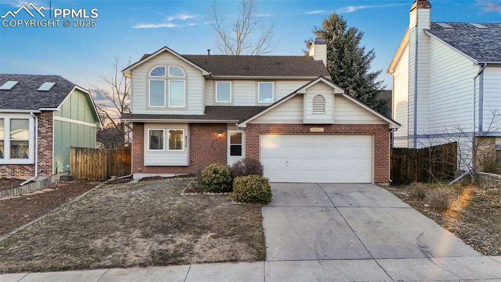 Traditional-style home with a garage, brick siding