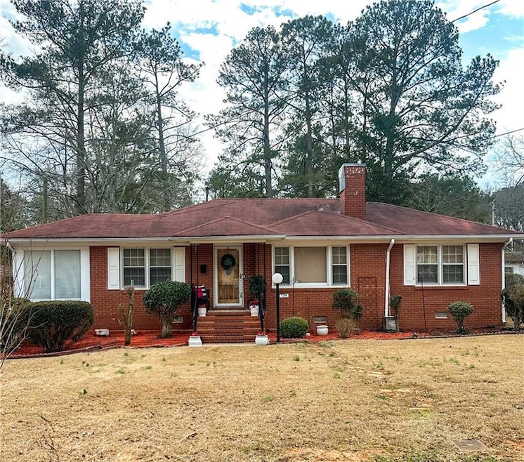Single story home featuring a front lawn