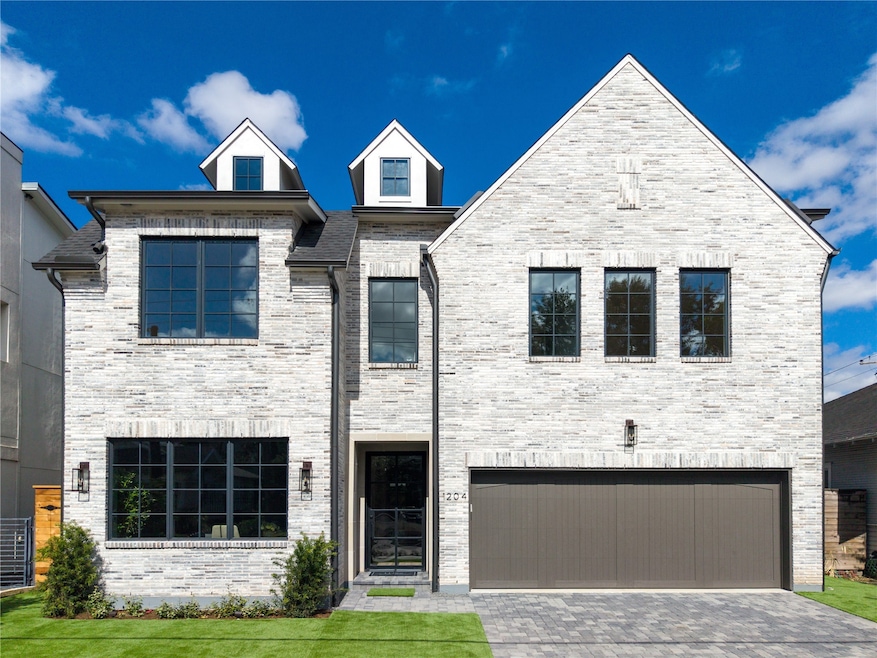 Stunning new construction in Montrose, minutes away from endless food and fun. Gray brick encases the exterior of the home in elegance, along with a plethora of windows. The property features a large, two-car garage and plenty of guest parking on the pavered drive. Lush landscape and no-maintenance turf complete the look.