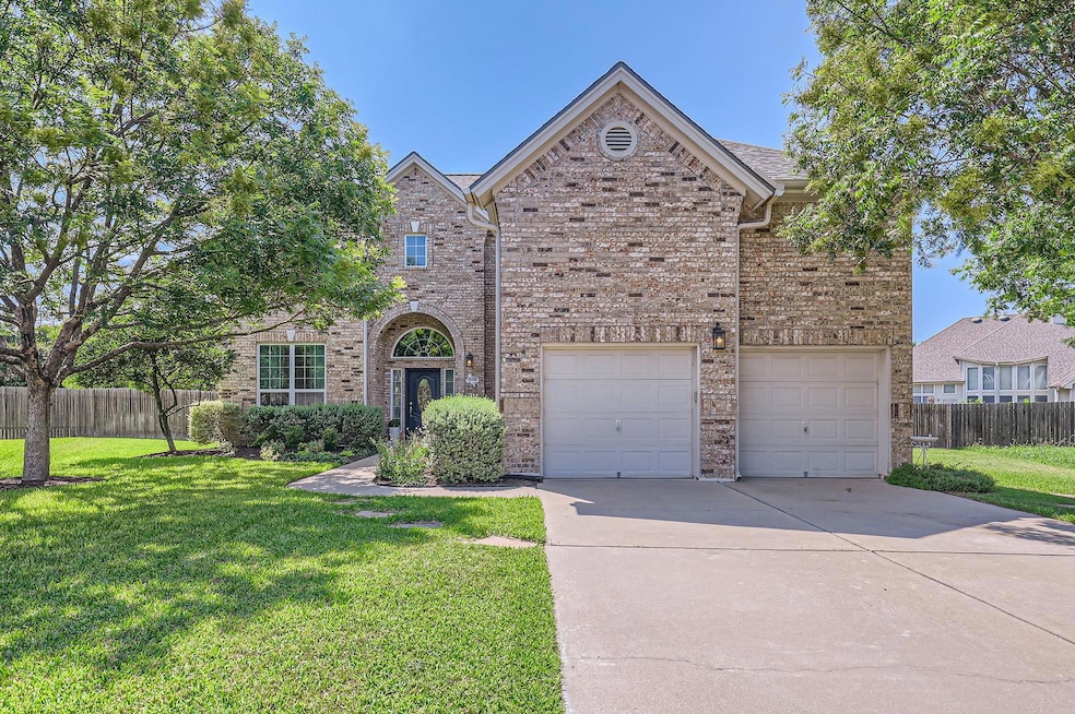 Traditional-style house with concrete driveway, b